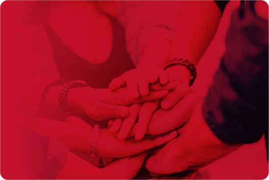 A group of friends putting their hand one over another.